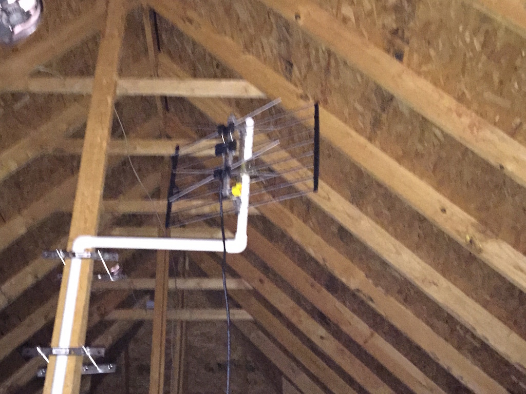 My antenna mounted in the attic. Sorry for the potato quality, I was
        standing on a ladder taking this picture.